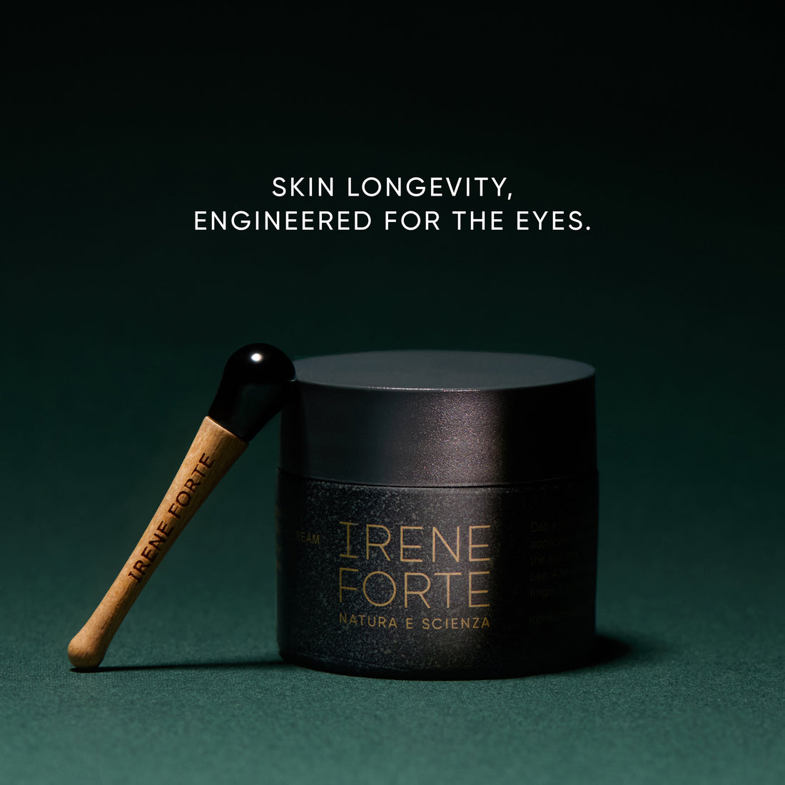 Irene Forte Skincare Phytomelatonin Rejuvenating Eye Cream shown with its black jar, dark green box, and a white eye-shaped cream dollop on a clean white background.